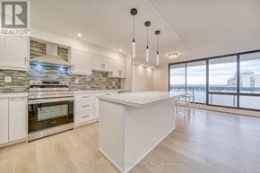 Toronto (Don Valley Village) condo for rent - A modern kitchen with a large island and a view of the city.