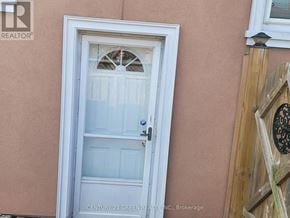 Toronto (West Hill) apartment for rent - A white door with a glass window and a metal handle.