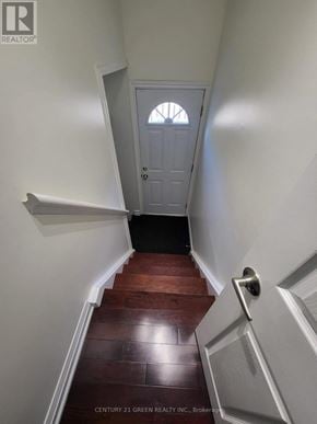 Toronto (West Hill) apartment for rent - A hallway with a wooden floor and white walls leading to a white door.