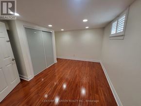Toronto (West Hill) apartment for rent - A room with wooden flooring and white walls.