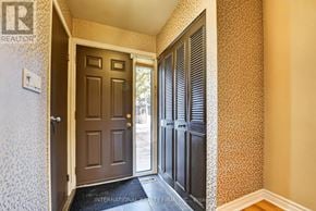 Mississauga (Meadowvale) townhouse for rent - A hallway with a closed door and a wallpapered wall.