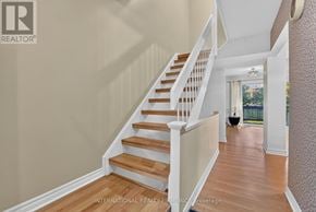 Mississauga (Meadowvale) townhouse for rent - A staircase with wooden steps and white railings.