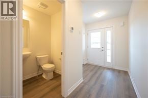 Kitchener apartment for rent - A bathroom with a toilet and a door.