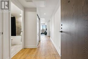 Toronto (Thorncliffe Park) condo for rent - A hallway with a door on the right and a window with curtains on the left.