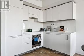 Toronto (Thorncliffe Park) condo for rent - A white kitchen with a refrigerator, oven, and cabinets.