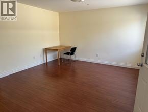 North Blackburn apartment for rent - A room with a wooden table and a black chair.