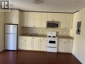 North Blackburn apartment for rent - A kitchen with white cabinets and appliances.