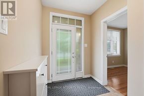 Ottawa apartment for rent - A white door with a glass panel is in the middle of a hallway.