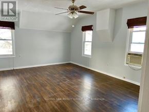 St. Catharines (Oakdale) duplex for rent - A room with a ceiling fan and wood flooring.