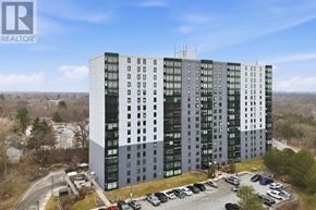 London South (South J) condo for rent - A tall building with a parking lot in front of it.