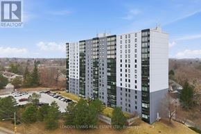 London South (South J) condo for rent - A tall building with a parking lot in front of it.