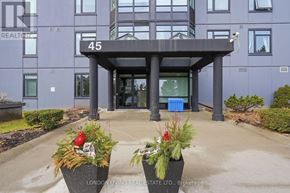 London South (South J) condo for rent - The entrance to a building with a sign that reads "45" and two planters with flowers in front.