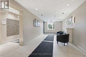 London South (South J) condo for rent - A hallway with a black chair and a black rug.