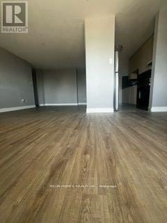 Toronto (Dorset Park) condo for rent - A room with wood flooring and a realtor logo.