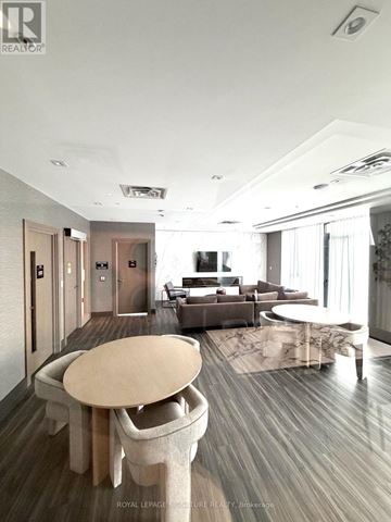 Hamilton (Corktown) condo for rent - A modern living room with a large table and chairs.