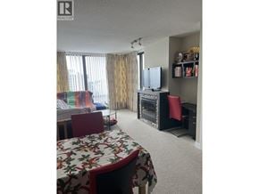 Burnaby apartment for rent - A bedroom with a bed, desk, and chair.