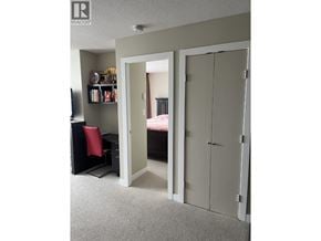 Burnaby apartment for rent - A bedroom with a bed, desk, and closet.