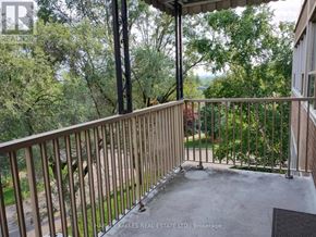 Toronto (Banbury-Don Mills) apartment for rent - A balcony with a metal railing and a view of trees.