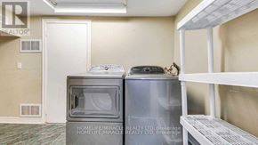 Toronto (Kennedy Park) apartment for rent - A small room with a microwave and a refrigerator.