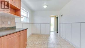Toronto (Kennedy Park) apartment for rent - A kitchen with white walls and a tiled floor.