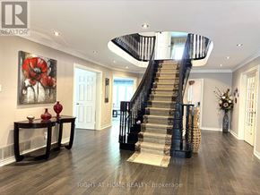 Richmond Hill (Mill Pond) apartment for rent - A spacious foyer with a staircase and a painting of red flowers on the wall.