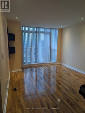 Toronto (Islington-City Centre West) condo for rent - A room with wooden flooring and a window with blinds.
