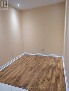 Toronto (Islington-City Centre West) condo for rent - A room with wooden flooring and beige walls.