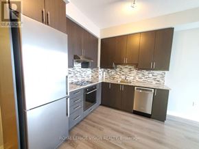 Toronto (Henry Farm) condo for rent - A kitchen with a refrigerator, cabinets, and a countertop.