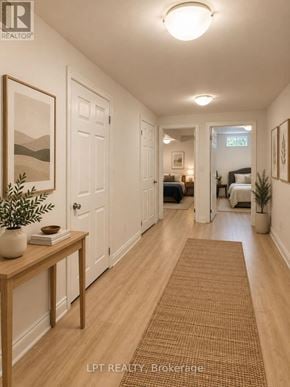 Mississauga (Churchill Meadows) apartment for rent - A hallway with a brown rug and a wooden table with a plant on it.