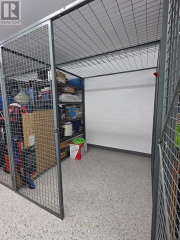 Mississauga (Central Erin Mills) condo for rent - A room with a white wall and a wire fence.