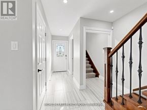 Oshawa (Samac) apartment for rent - A hallway with a staircase and a door at the end.