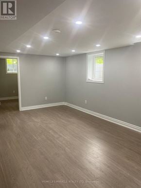 Brampton (Brampton South) apartment for rent - A room with wooden flooring and white walls.