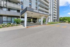 Burlington (Brant Hills) condo for rent - The entrance to a building with the sign 2055 Upper Middle Road.
