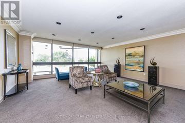 Burlington (Brant Hills) condo for rent - A living room with a glass table and chairs.