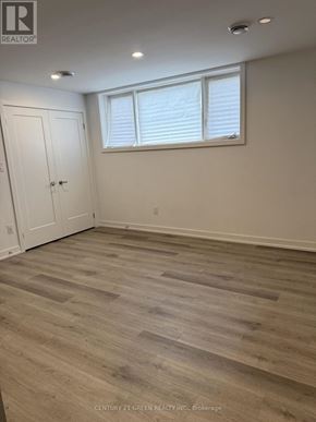 Niagara Falls (Downtown) condo for rent - A room with wooden flooring and a white door.