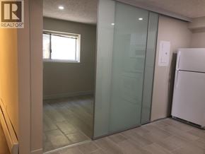 West Vancouver apartment for rent - A bedroom with a bed, nightstand, and lamp.