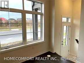 Markham (Cedar Grove) townhouse for rent - A room with a large window and a door leading to a balcony.