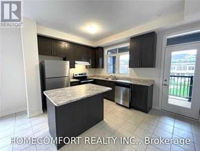 Markham (Cedar Grove) townhouse for rent - A kitchen with a marble countertop and stainless steel appliances.