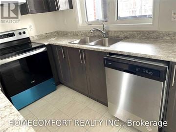 Markham (Cedar Grove) townhouse for rent - A kitchen with a stainless steel dishwasher and a blue trash bin.