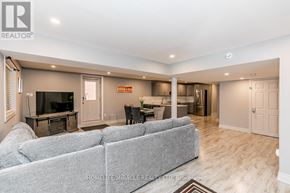 Barrie (Bayshore) apartment for rent - A living room with a grey couch and a television.