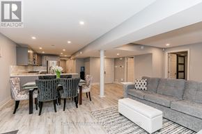 Barrie (Bayshore) apartment for rent - A well-lit, modern living room with a dining area and a kitchen in the background.