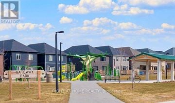 Barrie townhouse for rent - A playground with a green slide and a sign that says "Gateway Park".
