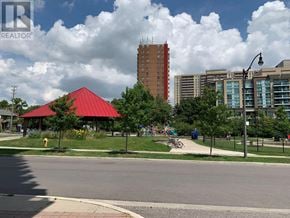 Toronto (Islington-City Centre West) condo for rent - A red-roofed pavilion is surrounded by trees and a fire hydrant in a park.