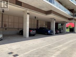 Toronto (Islington-City Centre West) condo for rent - A parking garage with cars parked in it.