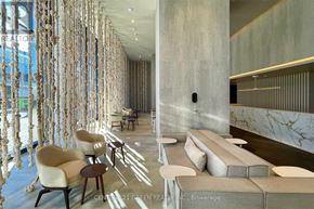 Toronto (Waterfront Communities) condo for rent - A modern interior with a long row of chairs and a long table.