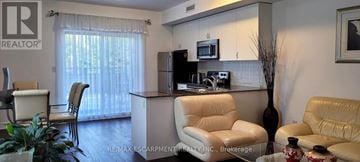 Toronto (Bathurst Manor) townhouse for rent - A living room with a white sofa and a white chair.