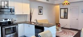 Toronto (Bathurst Manor) townhouse for rent - A kitchen with a stove top oven and a sink.