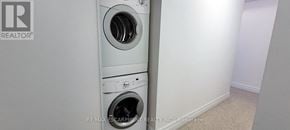 Toronto (Bathurst Manor) townhouse for rent - A white wall with a washing machine and dryer in the corner.