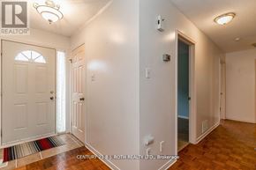 Barrie (Cundles East) apartment for rent - A brokerage sign is on the wall in a white hallway.