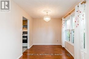 Barrie (Cundles East) apartment for rent - A room with a chandelier and a window with curtains.